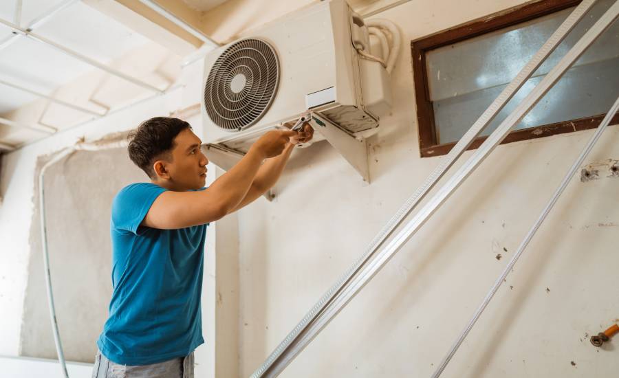 technician fixing aircon